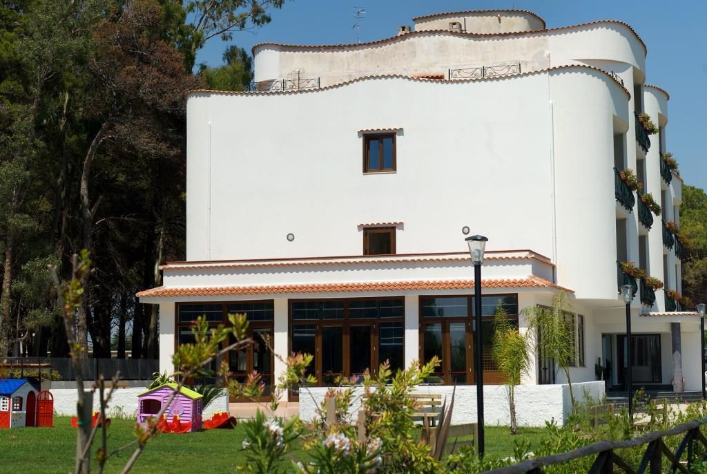 Rückansicht des Hotels mit Garten und kindgerechtem Spielhaus