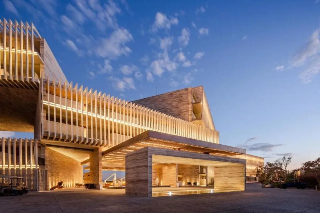 Moderne Hotelarchitektur mit Holz- und Glasakzenten unter blauem Himmel