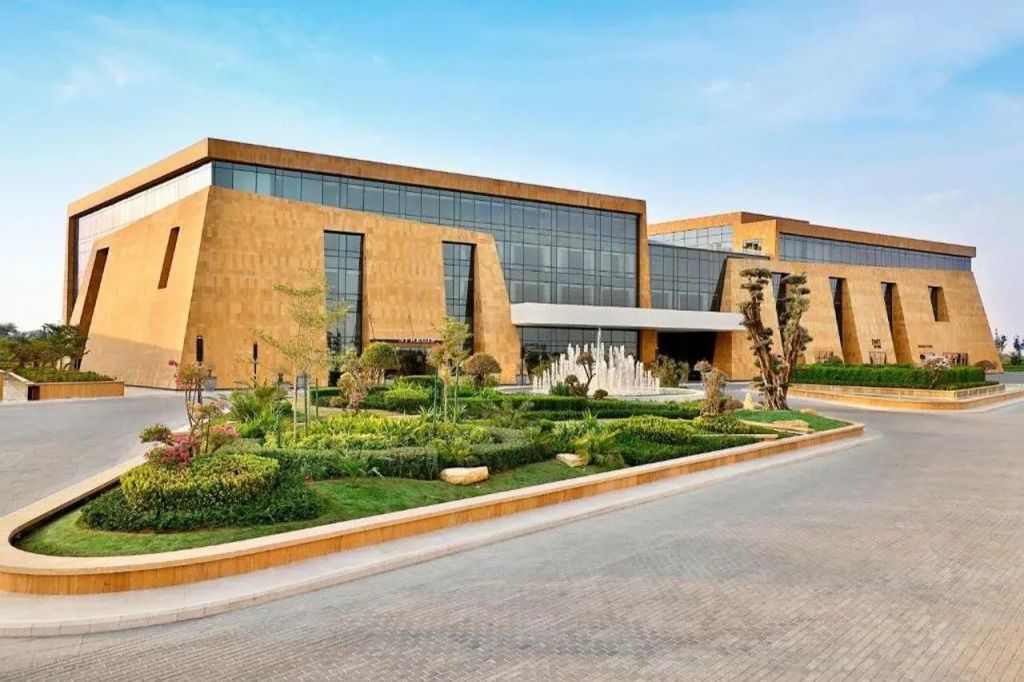 Moderne Hotelarchitektur mit gepflegtem Garten und breiten Fensterfronten